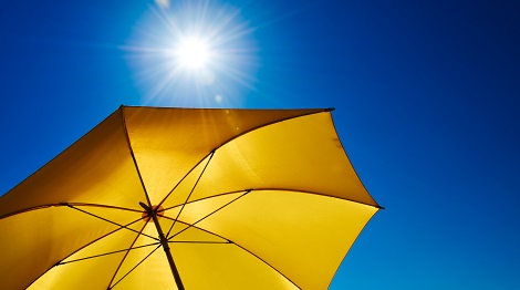 Yellow Umbrella With Bright Sun And Blue Sky