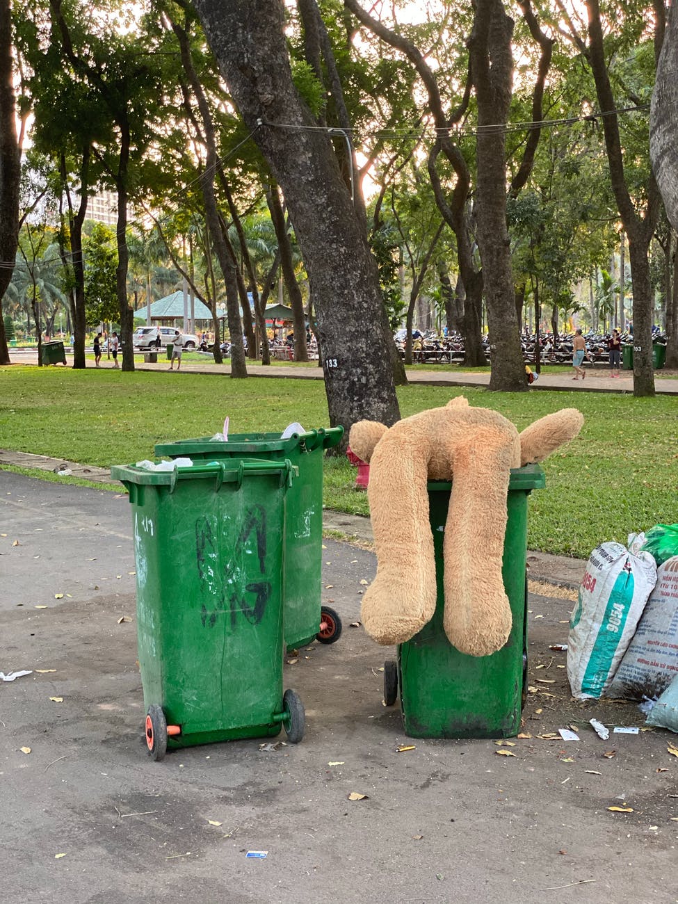 dirty trash containers near green park